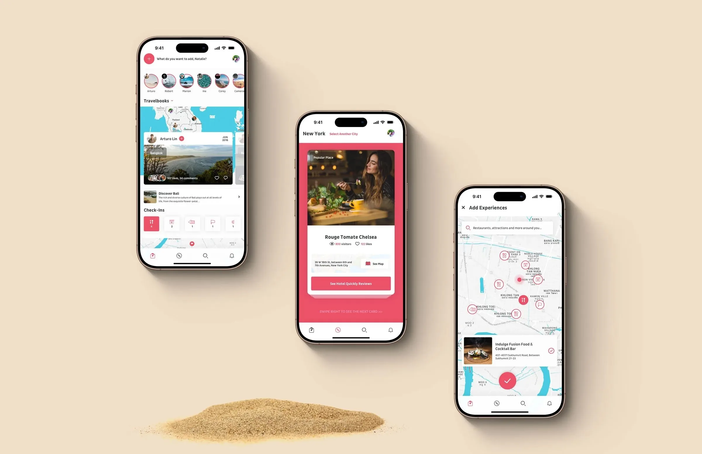 Three iPhones on warm sand-coloured backdrop, with a small mound of sand at the bottom. Left phone: Travelbook home for "Natalie" with a story-circles row, a Travelbooks map of Bali tagged "Arturo Lin", a "107 likes, 14 comments" card titled "Discover Bali", and a Check-ins strip below. Centre phone: a New York "Popular Place" card for Rouge Tomate Chelsea with a candid restaurant photo, ratings, address, and a coral "See Hotel Quickly Reviews" CTA. Right phone: an "Add Experiences" map screen scattered with restaurant pins around Bangkok, with an "Indulge Fusion Food & Cocktail Bar" result selected.